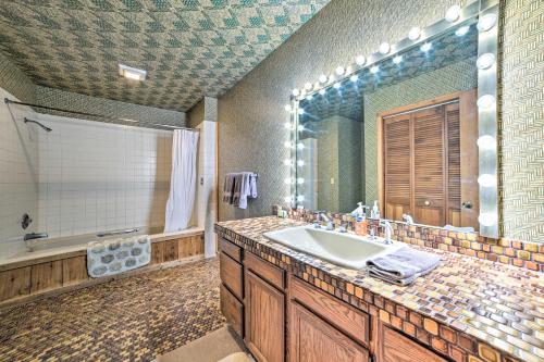 a bathroom with a sink and a large mirror at Bellaire Resort Condo Ski, Tube, Explore! in Bellaire