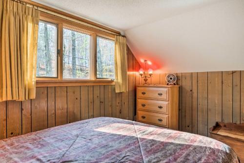 a bedroom with a bed and a dresser and windows at Mountain-View Conway Cabin about 9 Mi to Slopes! in Conway
