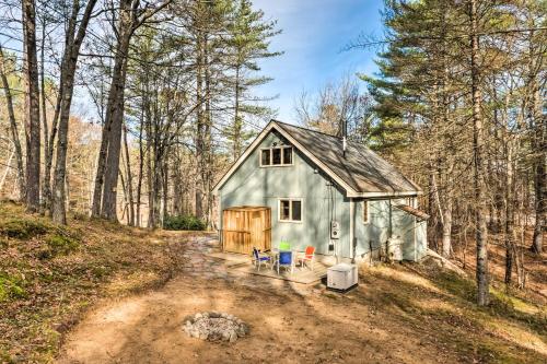 a blue barn in the middle of a forest at Mountain-View Conway Cabin about 9 Mi to Slopes! in Conway