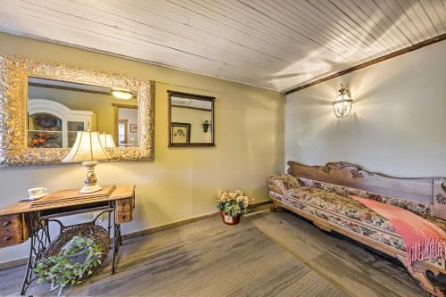 1 dormitorio con cama, mesa y espejo en The Farm House with Deck and Historic Charm! 
