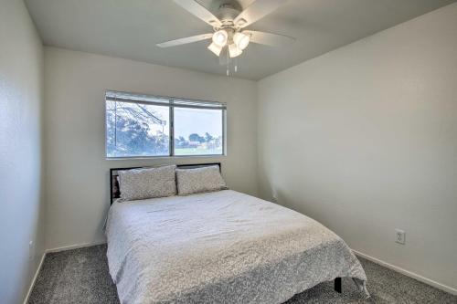 a bedroom with a bed and a ceiling fan at Comfy Bakersfield Townhome - Fire Pit and Patio in Bakersfield