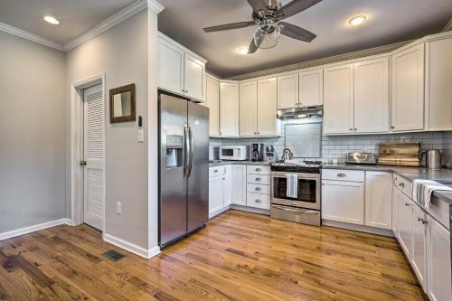 a kitchen with white cabinets and a stainless steel refrigerator at Charming Spring Lake Retreat, 1 Mi to Beach! in Spring Lake