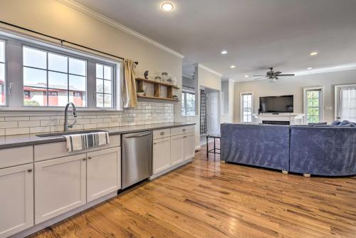 a kitchen with white cabinets and a blue island at Charming Spring Lake Retreat, 1 Mi to Beach! in Spring Lake