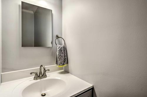 a white bathroom with a sink and a mirror at Charming Spring Lake Retreat, 1 Mi to Beach! in Spring Lake
