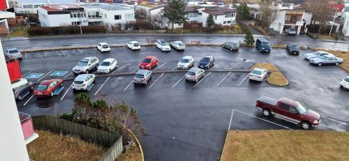 an aerial view of a parking lot with cars parked at City view, bright & cozy - Free parking (A4) in Reykjavík