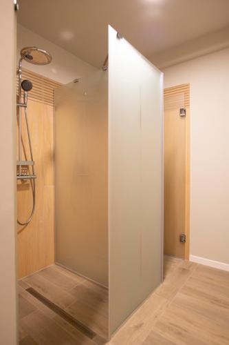 a shower with a glass door in a bathroom at Valley View Breaza in Breaza