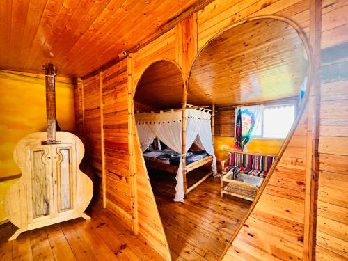a room with a bed in a wooden house at Maison du Bonheur in Dakar