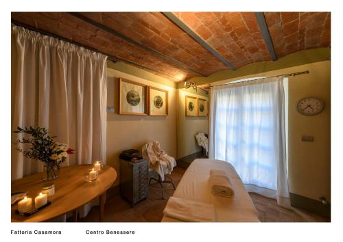 a living room with a table and a window at Fattoria Casamora - Suites in Pian di Scò
