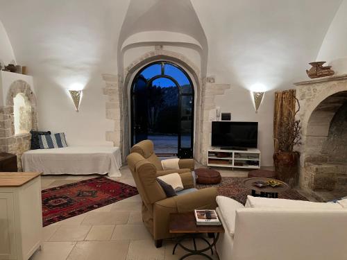 a living room with a couch and a fireplace at Villa del 1700 immersa nel verde, Poggio al Sole Vieste in Vieste