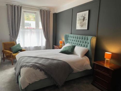 a bedroom with a large bed and a window at TW O Connell old world Irish pub in Cahersiveen