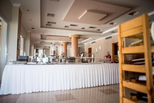 a large kitchen with a long white counter top at Elektra Hotel in Paleros