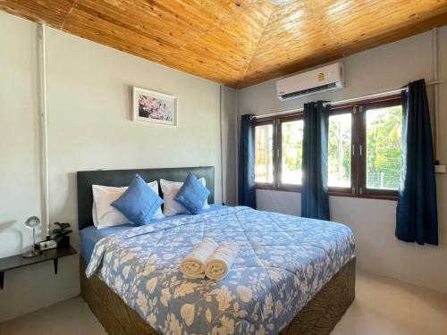 a bedroom with a bed with two towels on it at MOOK BOONCHU HOTEL in Koh Mook