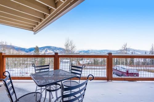 a patio with a table and chairs on a balcony at 2 Bed 1 Bath Apartment in Wildernest, CO in Silverthorne