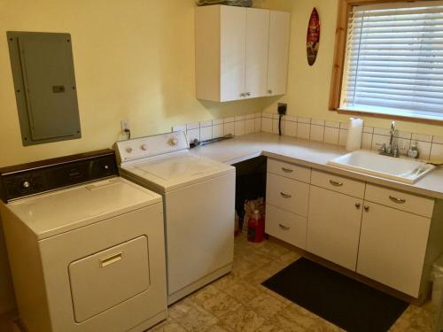 a small kitchen with a dishwasher and a sink at Boulder Creek Cabin by Casago McCall - Donerightmanagement in Donnelly