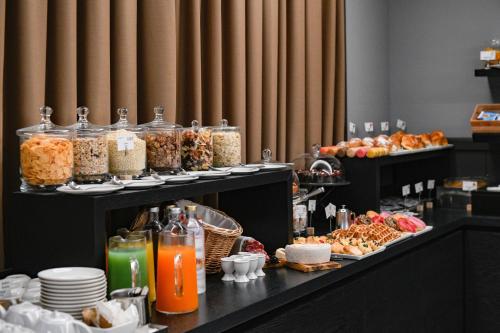 a buffet of food and drinks on a table at Albergo Locanda Primavera in Rodengo Saiano