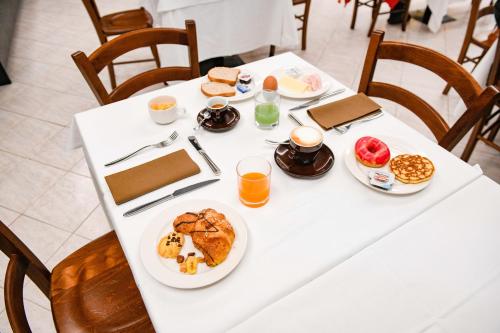 a white table with breakfast foods on it at Albergo Locanda Primavera in Rodengo Saiano