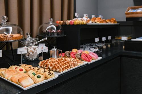 a buffet of different types of pastries on display at Albergo Locanda Primavera in Rodengo Saiano