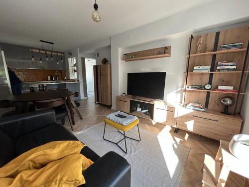a living room with a couch and a table at Simply Yellow Apartment in Lisbon