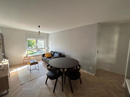 a living room with a table and chairs and a couch at Simply Yellow Apartment in Lisbon