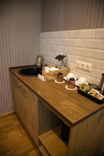 a kitchen counter with a sink and some food on it at Old Riga Plaza Hotel in Riga