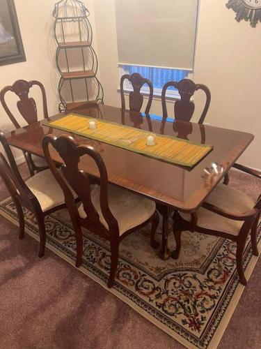 a dining room table with chairs and a wooden table at Entire Private 2 bedrooms house, nice neighborhood in Arnold
