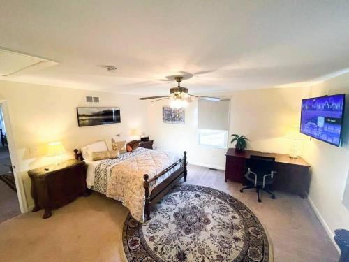 a bedroom with a bed and a desk and a tv at Entire Private 2 bedrooms house, nice neighborhood in Arnold