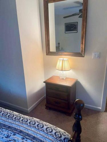 a bedroom with a table with a lamp and a mirror at Entire Private 2 bedrooms house, nice neighborhood in Arnold
