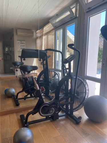 two bikes are parked in a room with windows at Atrium Hotel in Agia Paraskevi