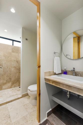 a bathroom with a sink and a toilet and a mirror at Lago Zirahuén By HomiRent in Mexico City