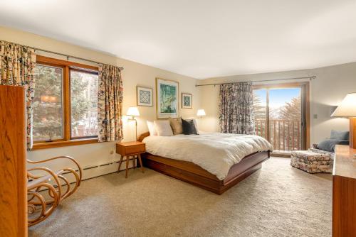 a bedroom with a bed and a large window at Cascade Village Area 5 bed 4 bath, Walk to lift! in Vail