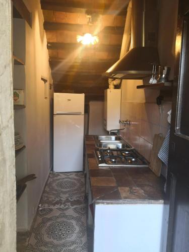 a kitchen with a white refrigerator and a stove at Affittacamere Serenità in Umbertide
