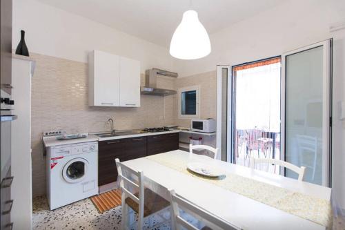 a kitchen with a sink and a washing machine at Old Town House Polignano a Mare in Polignano a Mare