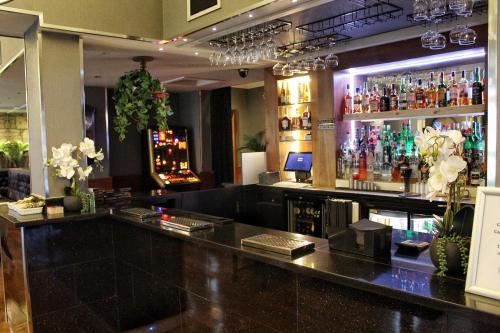 un bar con un montón de botellas de alcohol en Best Western Glasgow Hotel, en Glasgow