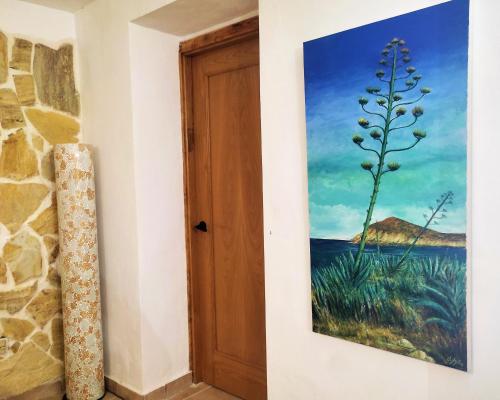 a painting on a wall next to a door at Casa Rural Villa Sargento in Níjar