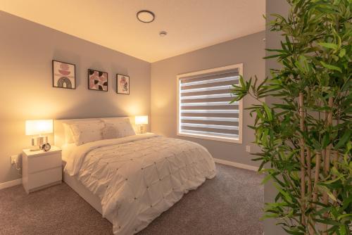 a bedroom with a bed and a window at You will love this 2BR Guest Suite in SE Calgary in Calgary