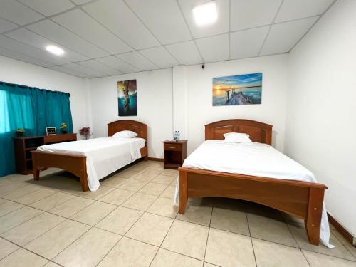 A bed or beds in a room at Majahual Resort