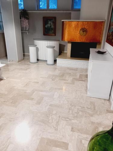 a room with a stone floor with a fireplace at Wendy House Apartament in Bari
