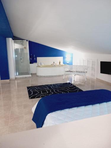 a bathroom with a bed and a shower and a sink at Wendy House Apartament in Bari