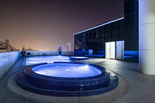 a large hot tub in a room with a building at Luxury Apt - Rooftop Pool - City View in Dubai
