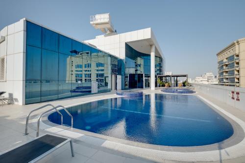 a large swimming pool on the roof of a building at Luxury Apt - Rooftop Pool - City View in Dubai