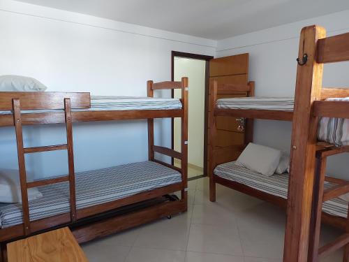a room with three bunk beds in a room at Casarão Nazaré Hostel in Salvador