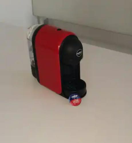 a red and black toaster sitting on a shelf at Loft Barbara in Velden am Wörthersee