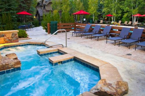 a large swimming pool with chairs and umbrellas at Arrowhead Escape in Edwards