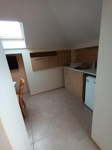 a small kitchen with a sink and a refrigerator at Guest rooms Bansko in Bansko