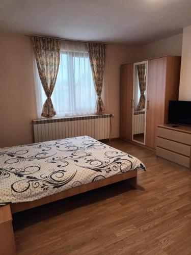 a bedroom with a bed and a large window at Guest rooms Bansko in Bansko