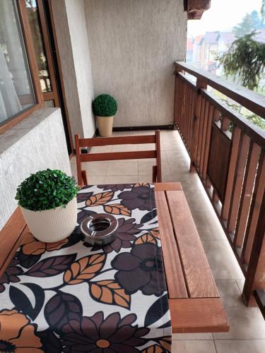 a balcony with a table and a potted plant at Guest rooms Bansko in Bansko
