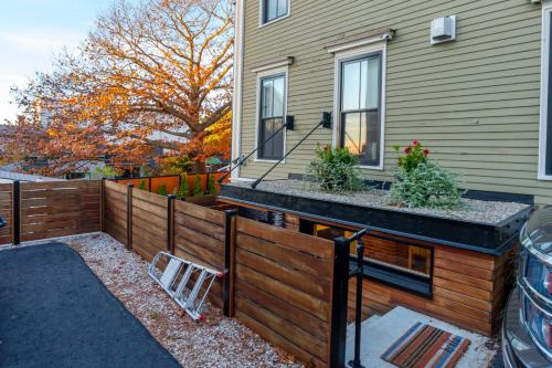 a wooden fence in front of a house at A Foodies Delight and Cumberland Charm in Portland