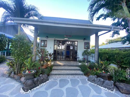 a house with a staircase leading to the front door at Cabanes Des Anges in La Digue