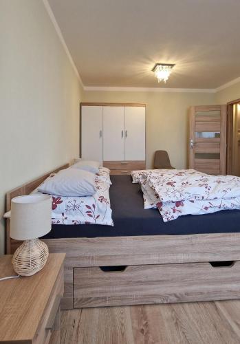 a bedroom with two beds and a table with a lamp at TEPLA in Teplice