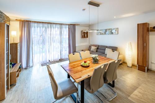 a dining room and living room with a table and chairs at Apartment-Alpenfantasie in Zell am See